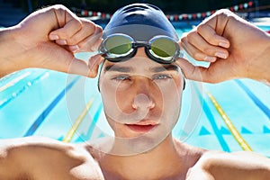 Driven to sporting excellence. Cropped portrait of a handsome male swimmer getting ready to compete.