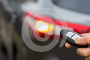 Close Up Of Driver Activating Car Security System With Key Fob