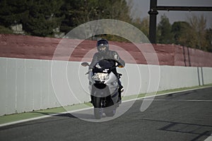 Driver on a Big sports bike model BMW k1200 on the circuit in Spain