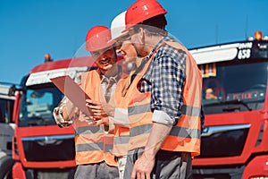 Driver and booker of heavy transport cargo company photo