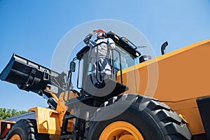 Driver of bulldozer, industry man builder on construction site. Concept mining machinery
