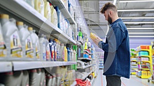 driver is buying motor oil in store with goods for automobiles