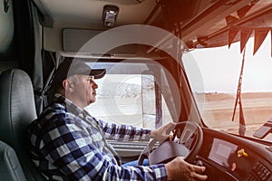 Driver in cabin of big modern truck