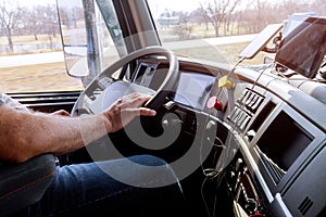 Driver in cabin of big modern truck