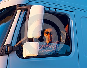 Driver in the cabin him truck photo