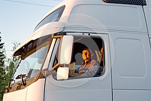 The driver in a cabin of the truck photo