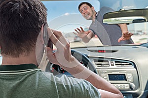 Driver calling using smartphone in car is going to hit pedestrian