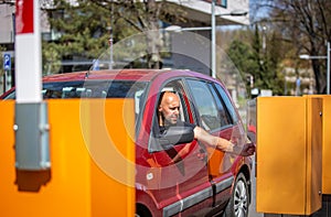 A driver of the car paying parking by a credit card, payment process