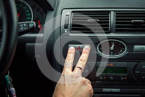 A driver in a car performs tasks necessary to steer the vehicle