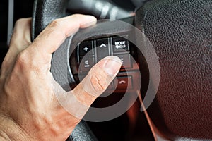 A driver is controlling on multifunction steering wheel.