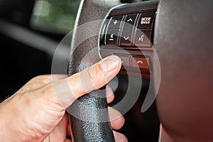 A driver is controlling on multifunction steering wheel.