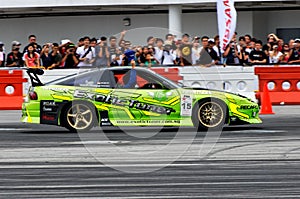 Driver drifting and waving to audience