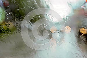 Driver eyes view of raindrops on car windshield on rainy day