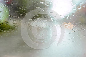 Driver eyes view of raindrops on car windshield on rainy day