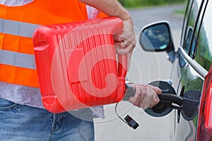 Driver fills the fuel in an empty car tank from canister