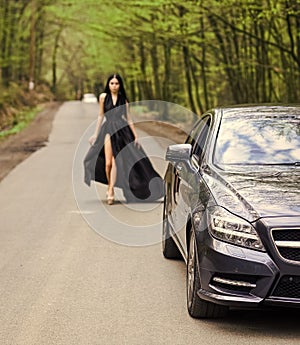 Driver girl. Beauty and fashion. Woman in black dress. Elegant lady escort service worker. Sexy girl elegant dress at