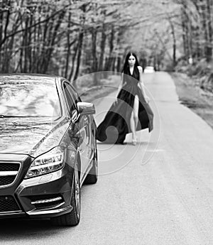 Driver girl. Beauty and fashion. Woman in black dress. Elegant lady escort service worker. Sexy girl elegant dress at