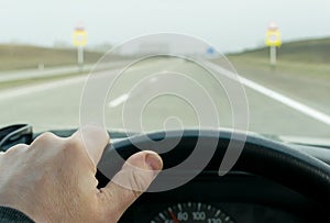 Driver hand on the steering wheel