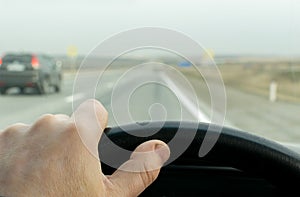 Driver hand on the steering wheel