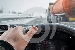 Driver hand on the steering wheel inside the car