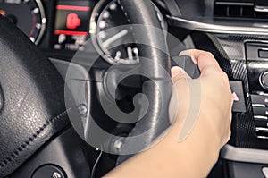 Driver handling the car`s direction indicator