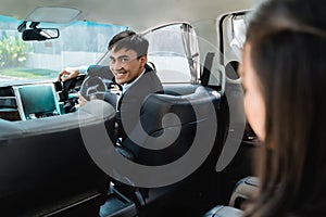 Driver in his suit driving luxurious car