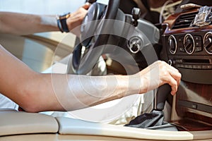 Driver man hand holding automatic transmission in car