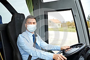 Driver in medical mask driving intercity bus