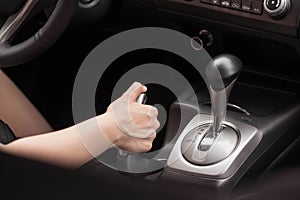 Driver pulling the hand brake in car. Close up