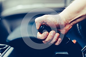 The driver pulls the hand brake lever. Male hand pulling the Parking brake using the hand brake lever. Hand brake for emergency st