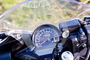 Driver riding motorcycle on an asphalt road in a tropics