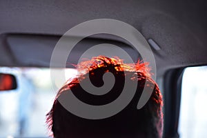 Driver`s hair with red coloured reflection stock photo