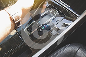 The driver`s hand moved the gear selector to the drive D mode