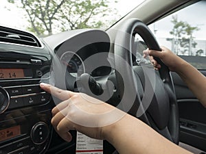Driver& x27;s Hand Press Button on Car Radio