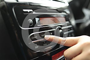 Driver& x27;s Hand Press Button on Car Radio