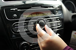 Driver& x27;s Hand Press Button on Car Radio