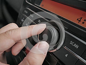 Driver& x27;s Hand Press Button on Car Radio