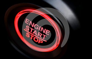 The driver`s hand is pressing the car start button. Concept of transportation and technology