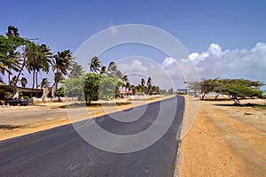 Driver's view of coastal highway leading to Palm Beach in the island of Aruba.