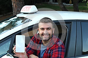 Driver showing mobile phone screen with a smile