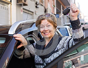 Driver standing with car key