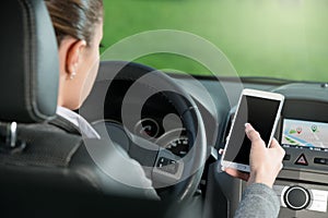 Driver using smartphone and gps navigation in a car