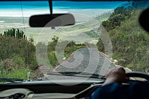 Driver viewpoint from a safari car vehicle of the Ngorongoro Crater in Tanzania, from the road leading to the bottom