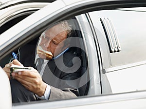 Driver Of White Limousine Eating Lunch Inside Car