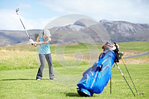 Driver, woman or golfer playing golf for fitness, workout or exercise with a swing on a green course. Wellness, girl