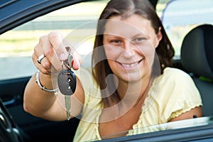 Driver woman smiling showing new car keys
