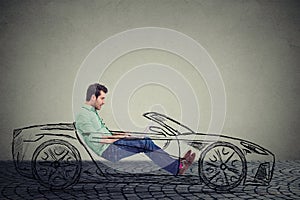 Driverless car technology concept. Man using laptop computer while driving a car photo