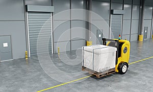 Driverless robotics car forklift robot lifting and moving pallets cardboard box to storage room in the factory background.