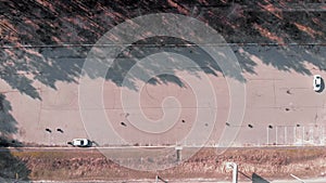 Drivers learn to drive cars at abandoned car parking lot. Aerial drone shot of cars drive on an abandoned road