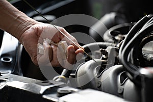 Drivers are Pulling the engine oil level dipstick To check the quality of engine oil. transportation concept